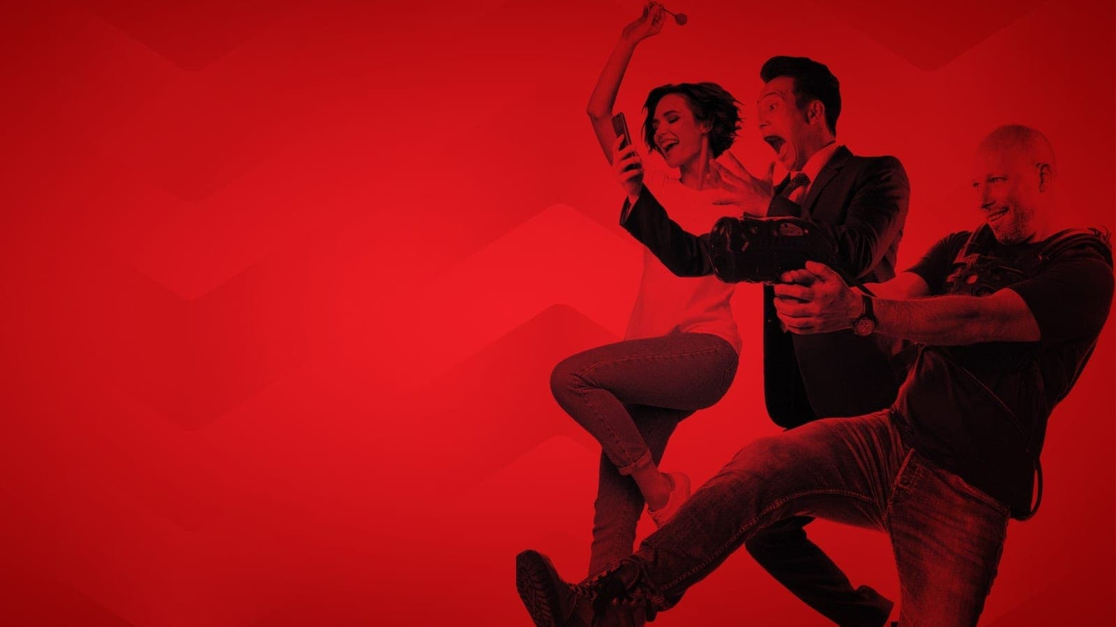 three adults laughing and aiming laser-tag guns in red duotone
