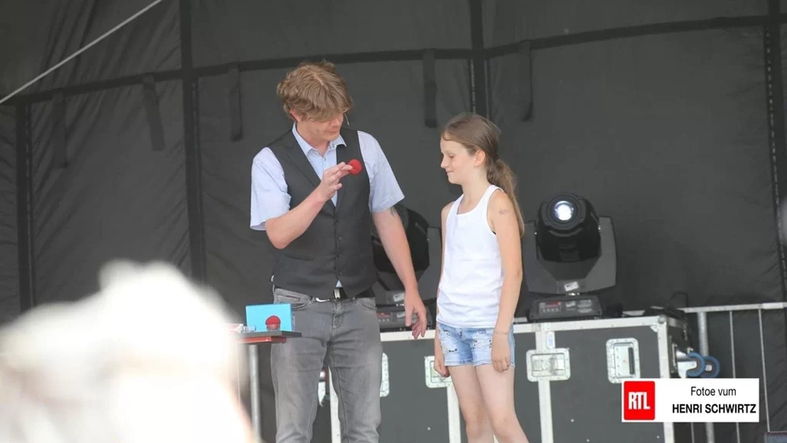 Christian Lavey performing a magic trick for children